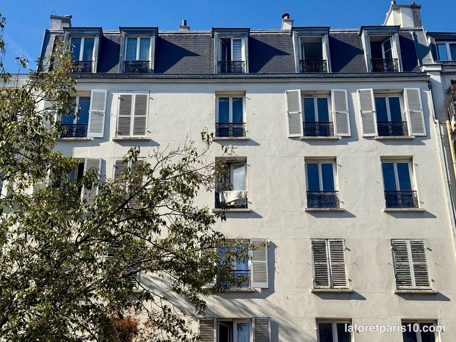 You are currently viewing 203 rue du Faubourg Saint-Martin, Paris 10e — immeuble de 1914 sous comble mansardé