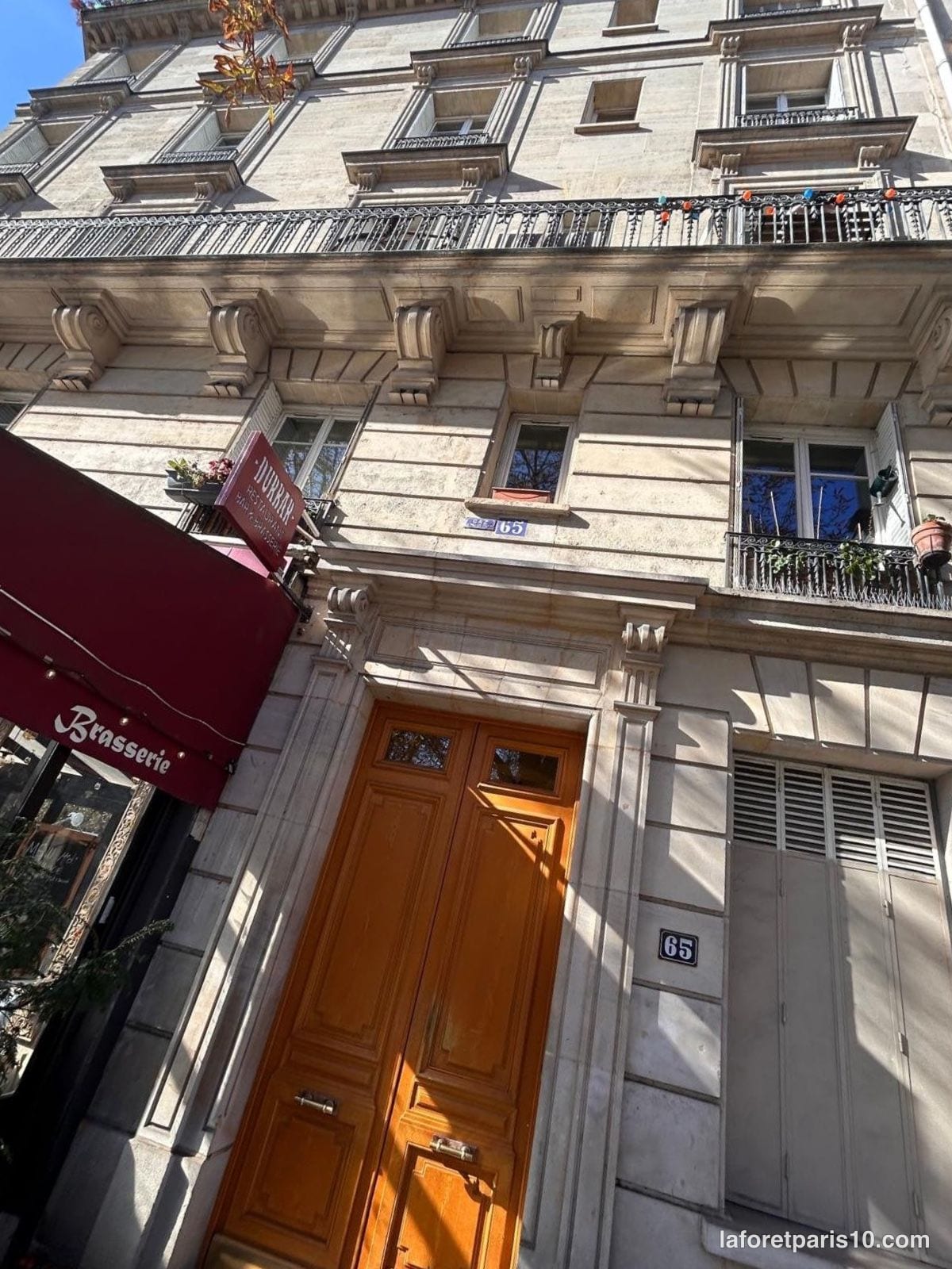 You are currently viewing 65 rue Manin, Paris 19e — immeuble en pierre de taille face aux Buttes-Chaumont